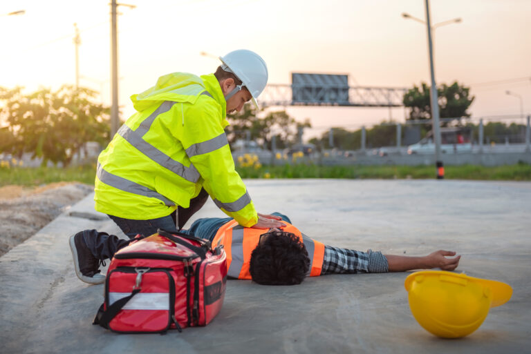 Accident at work of construction labor people, Basic First aid and CPR Training at outdoor. Heat Stroke or Heat exhaustion in body concept.